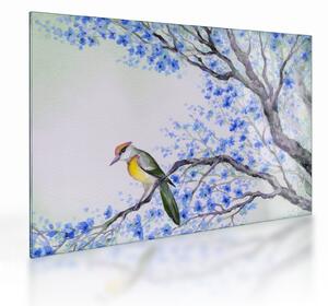 Tablou pe sticlă - Pasăre pe un copac cu flori albastre (70x50 cm)