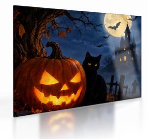 Tablou pe sticlă - Pisică neagră lângă un dovleac luminat de Halloween (70x50 cm)