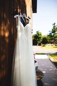 Fotografie de artă Beautiful white wedding dress hanging elegantly, Wirestock, (26.7 x 40 cm)