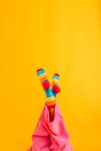 Fotografie de artă Woman wearing colorful socks against yellow, Westend61, (26.7 x 40 cm)
