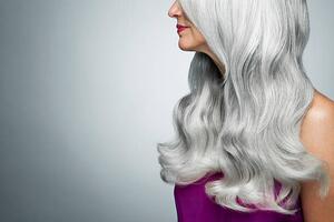 Fotografie Cropped profile of a woman with long, gray hair., Andreas Kuehn, (40 x 26.7 cm)