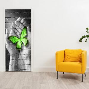 Fototapeta pentru ușă - Fluture verde în palmă (95x205cm)