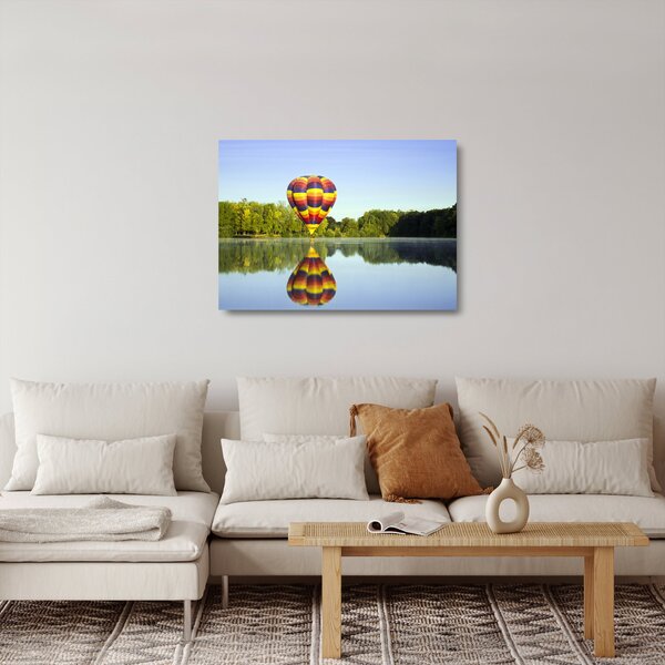 Tablou pe sticlă cu balon cu aer cald pe un lac (70x50 cm)