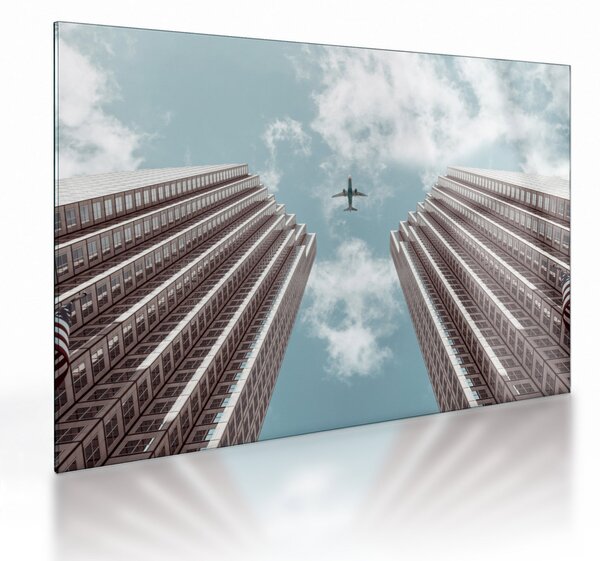 Tablou pe sticlă cuavion între clădiri (70x50 cm)