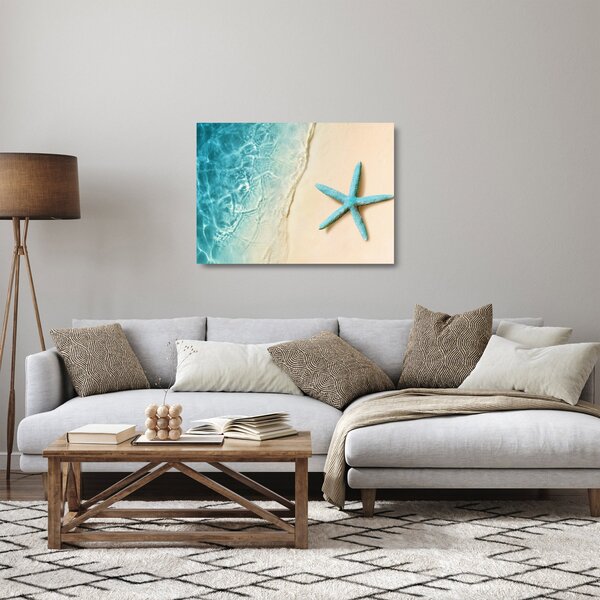 Tablou pe sticlă - Stea de mare pe plajă (70x50 cm)