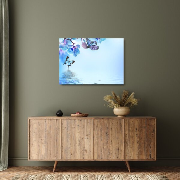 Tablou pe sticlă - Fluture pe flori de orhidee, albastru (70x50 cm)