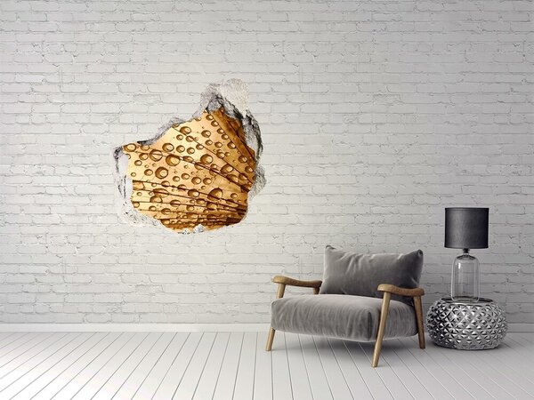 Autocolant gaură 3D O picătură aurie pe fundalul de beton