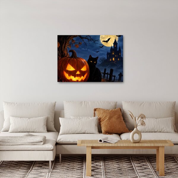Tablou - Pisică neagră lângă un dovleac luminat de Halloween (70x50 cm)